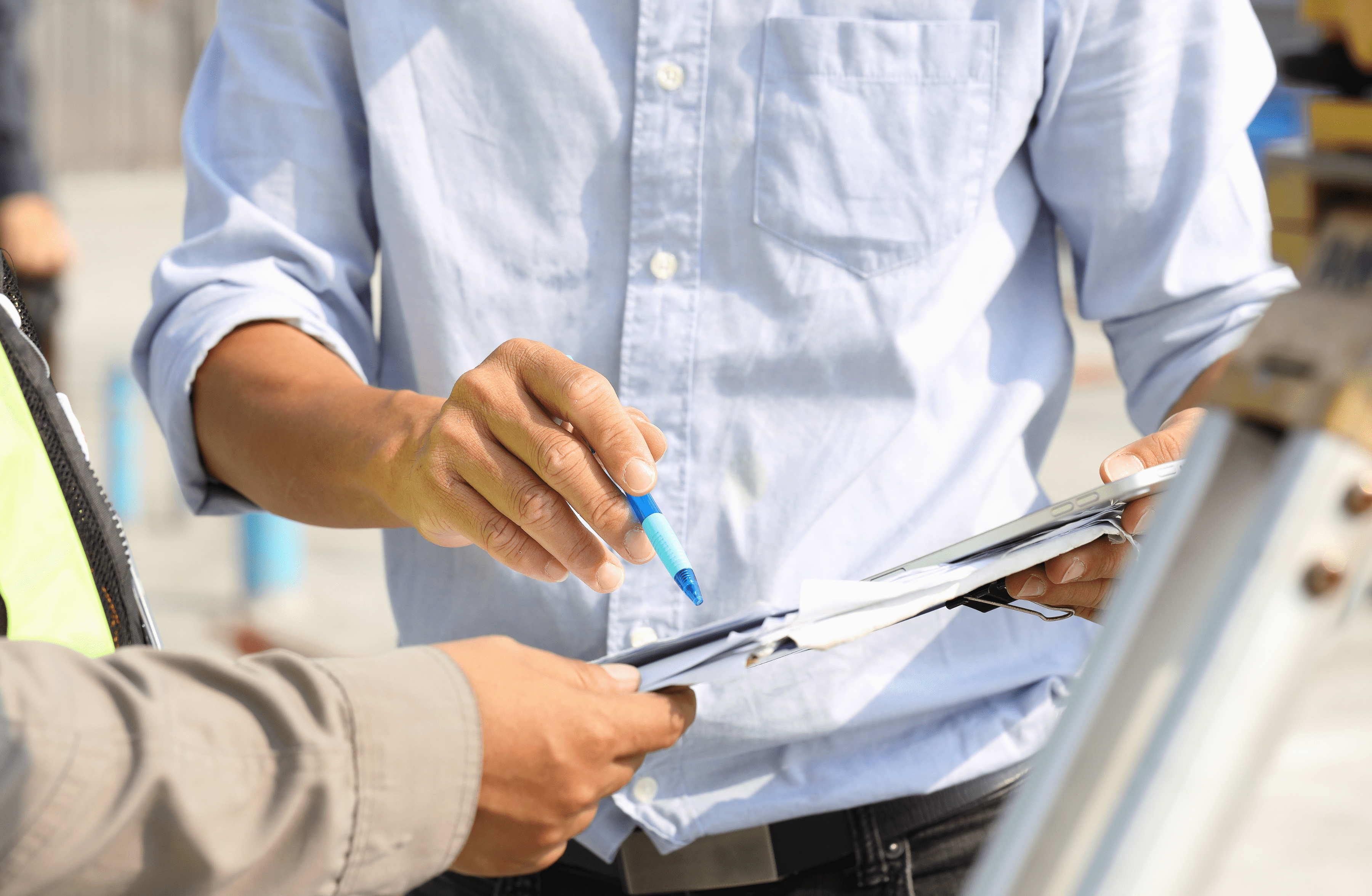 Stone Haven Developments Two people review documents outdoors at Stone Haven Developments; one person points at papers with a blue pen while the other holds the documents. Ontario
