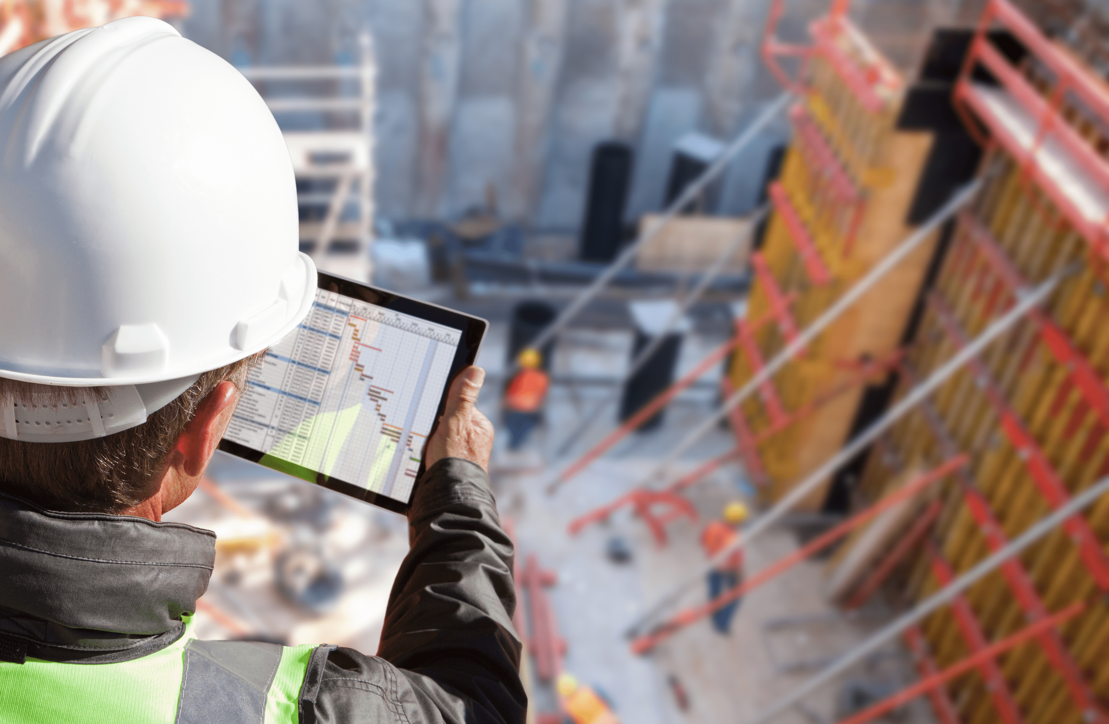 Stone Haven Developments A construction worker in a hard hat and safety vest reviews a project schedule on a tablet at an active Stone Haven Developments construction site. Ontario