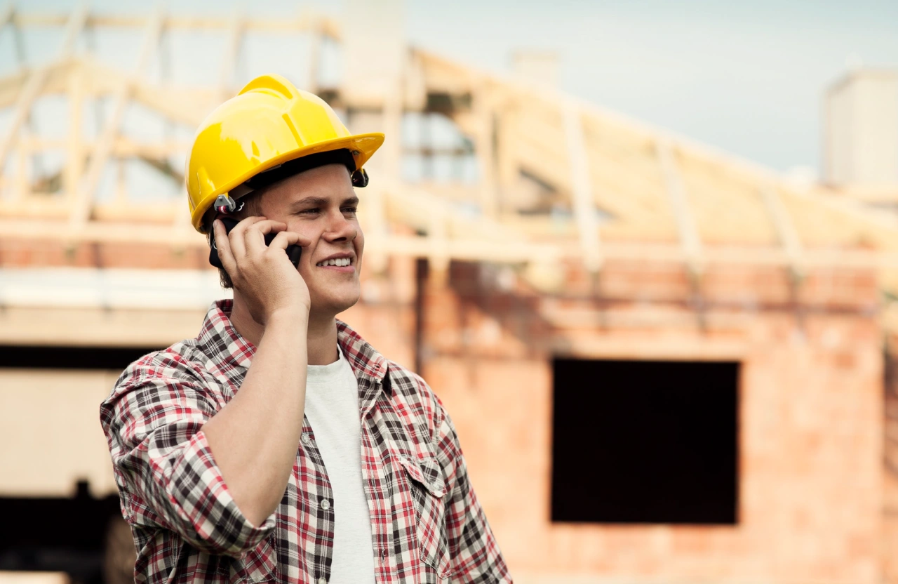 Contractor on the phone at a home renovation build site in Stratford, Ontario