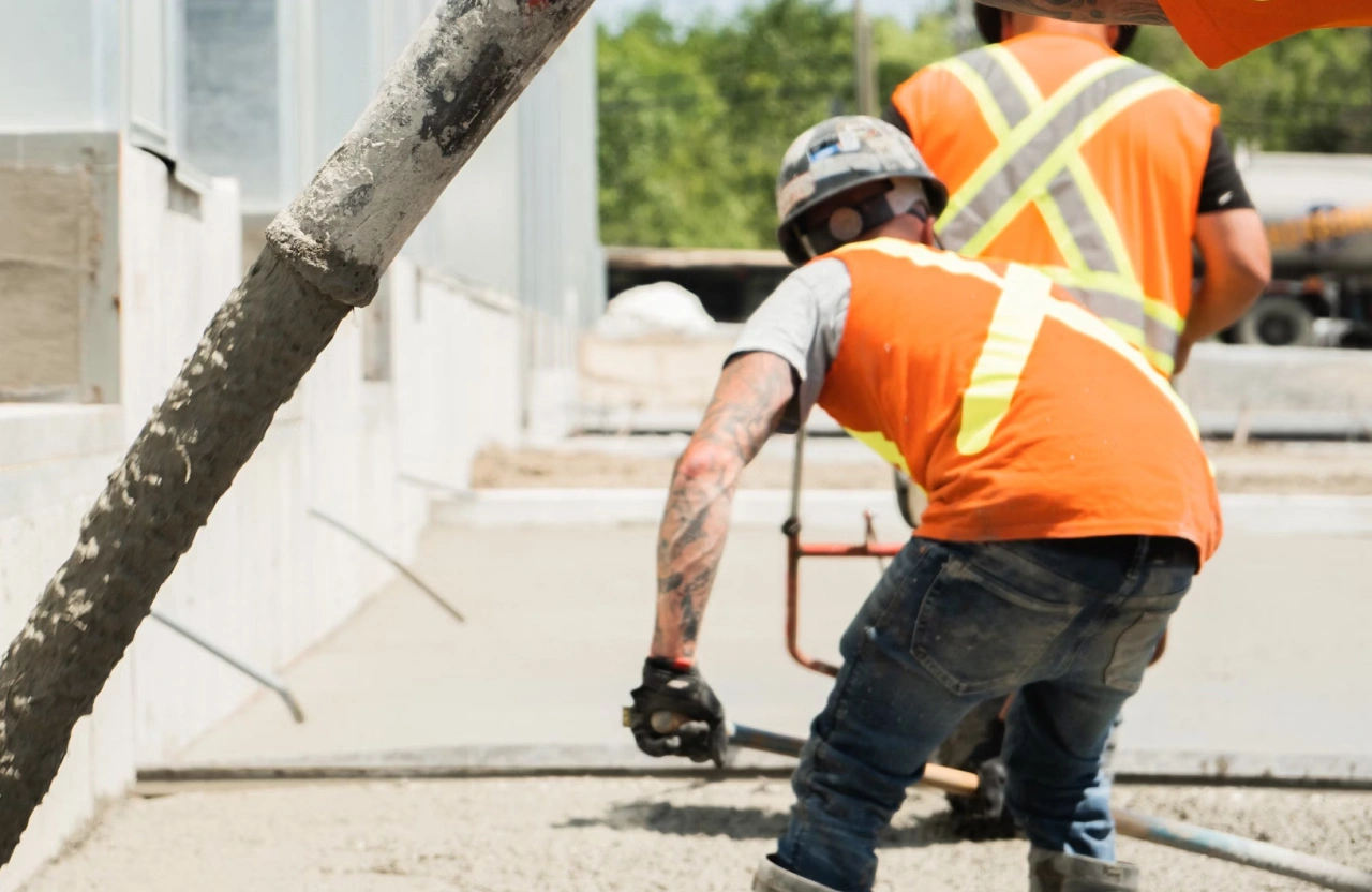 Construction professionals reviewing plans and managing a commercial construction project on-site